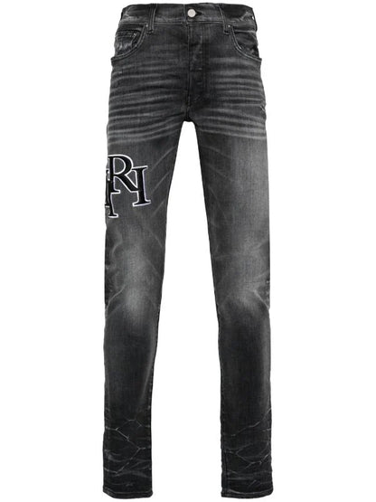 Amiri Men's Faded Skinny Jeans with Staggered Logo